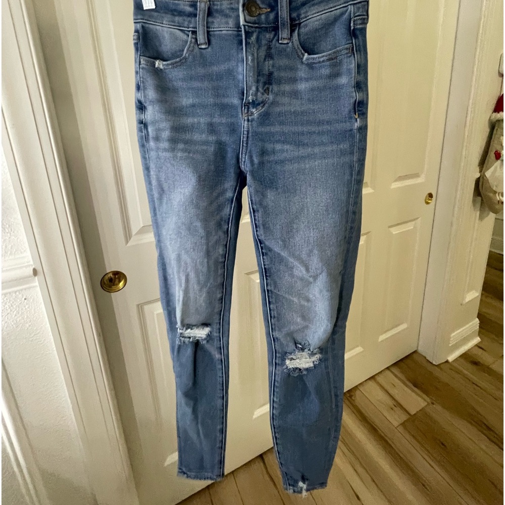 kind of worn, rips on the knees, skinny jeans